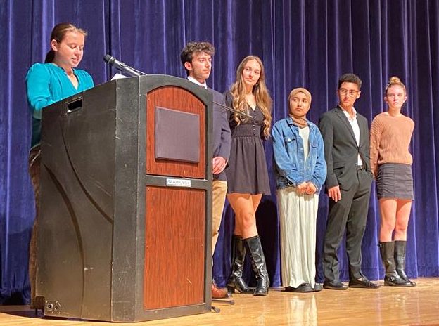 Student officers of the National Social Studies Honor Society speak at the induction ceremony on Nov. 1, 2022. Pictured, left to right: Vice president Gracie Schrader, president Alex Vega, secretary Emily Gibb and community outreach officers Aaima Naeem, Alex Treppiedi and Samantha Willis.
