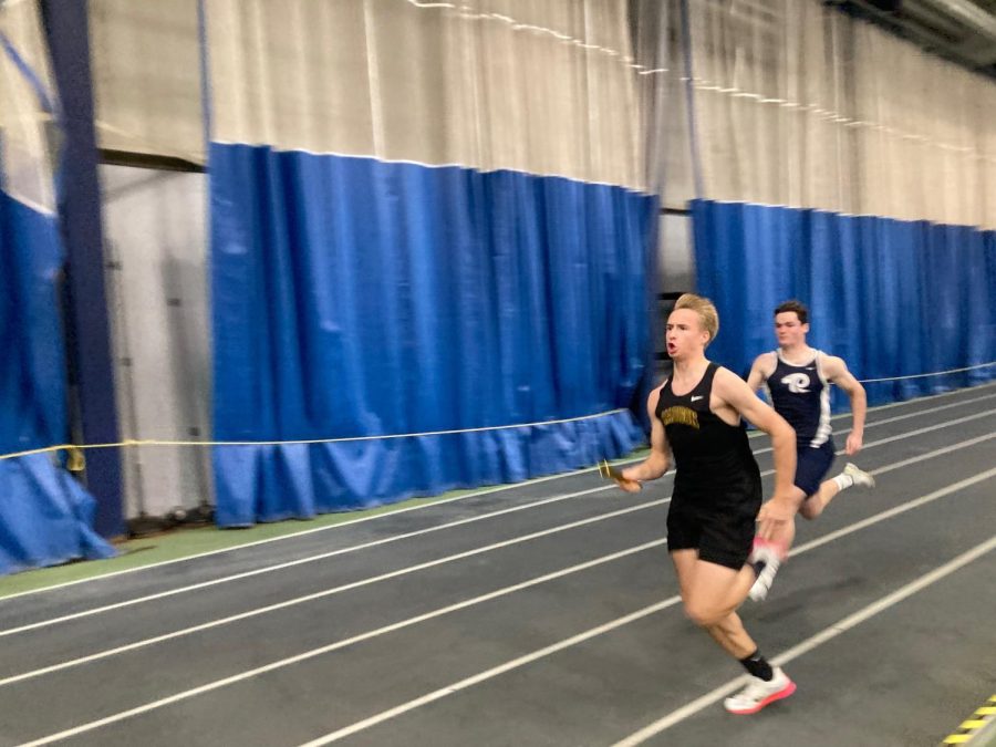 Boys Track and Field senior captain Dan Pinyan (rear) advances on another runner at an earlier meet, the Wayne Gardiner Relays. Pinyan and his teammates are hoping for a strong ending to their successful season at tonights Eastern States Championships at The Armory in New York City.

