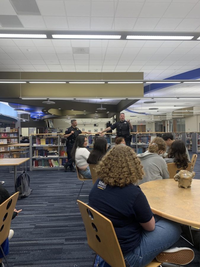 Randolph Police Officer Richard Biase and Sergeant Matt Rispoli speak to students in 
Angie Stierchs and Meghan Murphys senior English classes about their work in criminal justice, in the RHS Media Center on May 1, 2023.
