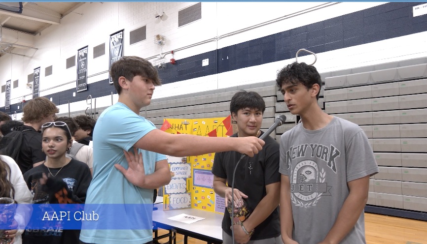 Cam Johnson interviews student leaders from the AAPI Club at the RHS Club Fair on Wednesday, Sept. 13, 2023