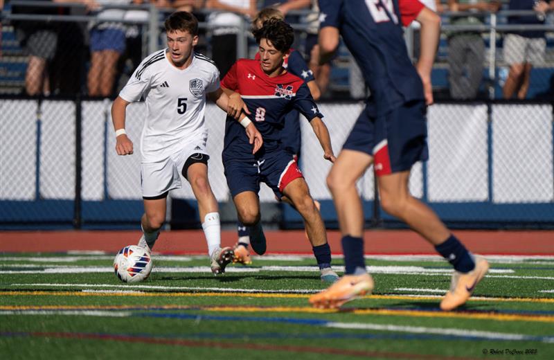 Boys Soccer made it to the semifinals in the MCT before being eliminated by Delbarton. Pictured: Sophomore Midfielder Robert Dougherty dribbles past two defenders @ Mendham in a pre-MCT game on Friday, Sept. 15, 2023. 