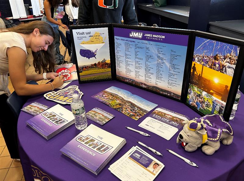 Senior Abby Lindsey checks in at the James Madison University (JMU) table at the annual College Fair, held in the high school Commons on Tuesday, Sept. 19, 2023. 