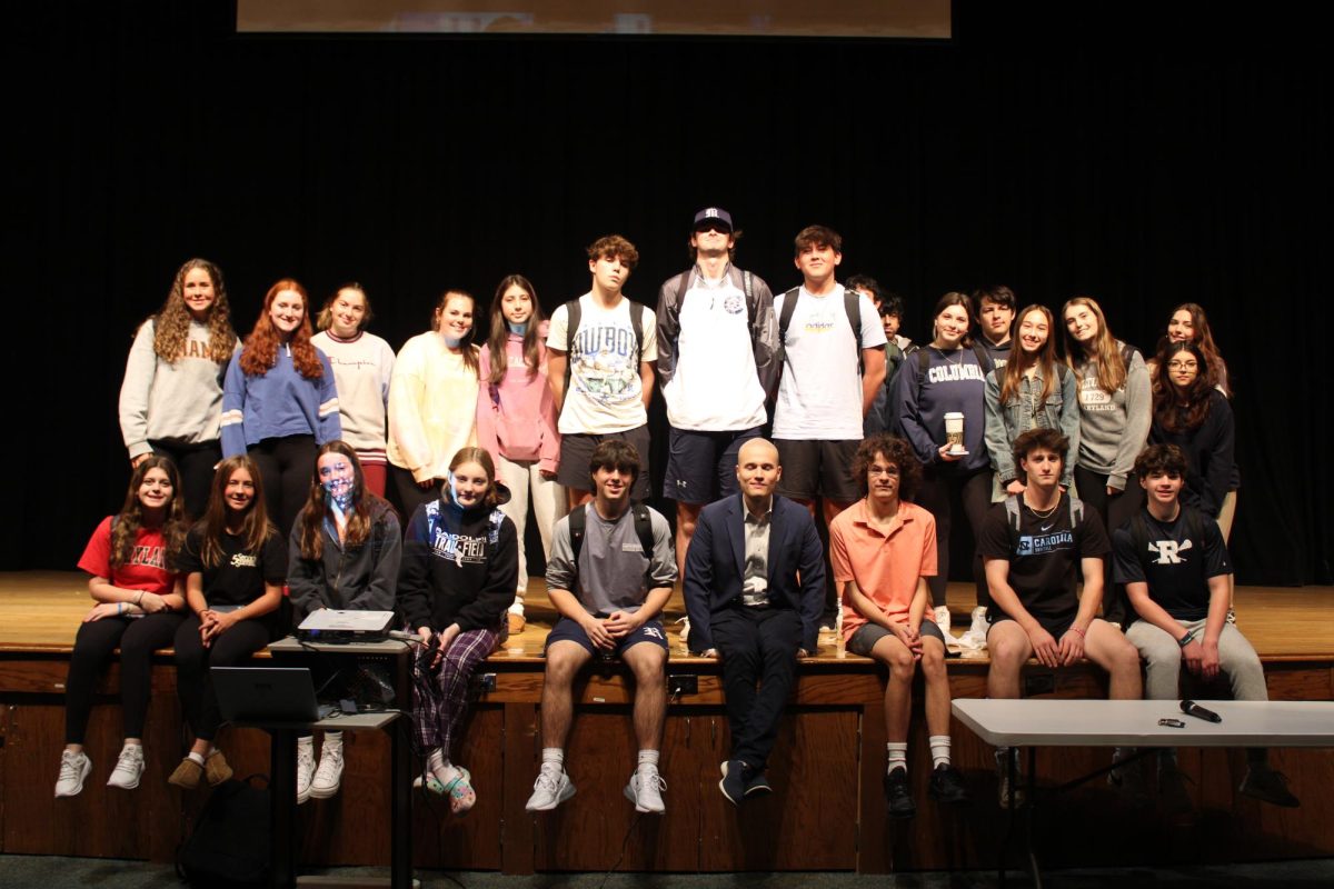 CBS Immigration Reporter and RHS Alumnus Camilo Montoya-Galvez (15) (seated, center) takes a pic with the journalism and media students after speaking to them, and later to the ESL students, at the high school on Friday, Oct. 27, in the auditorium. 