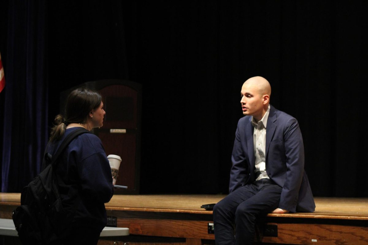 CBS Immigration Reporter and RHS Alumnus Camilo Montoya-Galvez  (15) speaks with junior Carly Ellermeyer after addressing the journalism, media and Heritage students at the high school on Friday, Oct. 27, in the auditorium. 