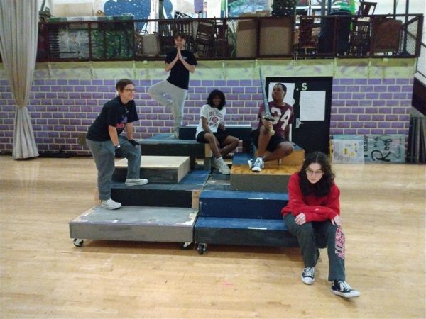 Members of the fall productions stage crew and actors demonstrate how the sets multilevel platform will be used during the performances. 