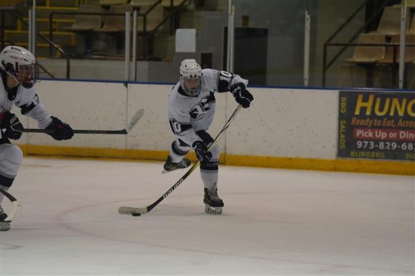 Sophomore Vincent Crisafulli shoots a goal against Morristown on Jan. 24. As of press time, Crisafulli has earned 25 points so far this season, with 11 goals and 14 assists.