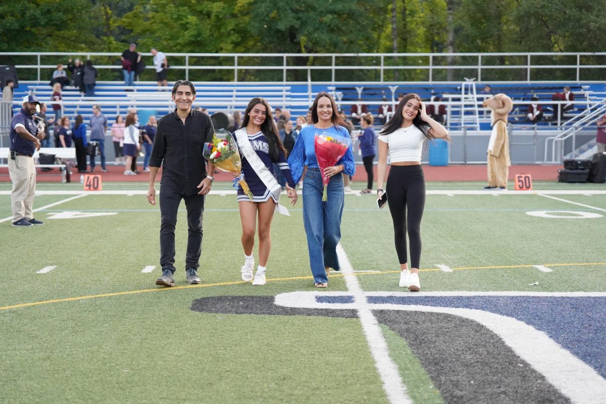 The Peretz-Gonzales family walks down the field (from left): Joel, Ella, Gallia, Mila