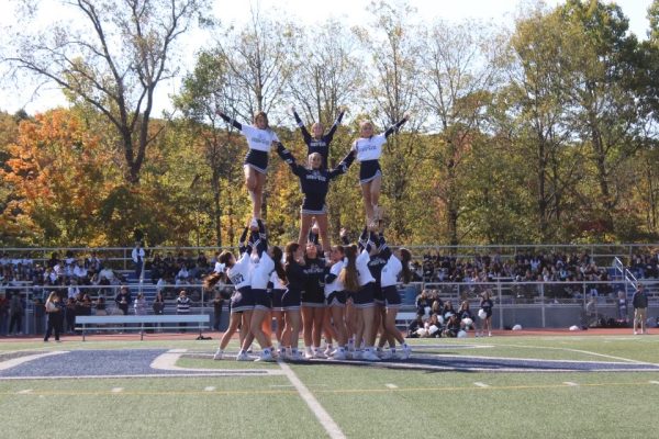 Varsity Cheer hypes up the crowd with their stunts at the Pep Rally.                                                              