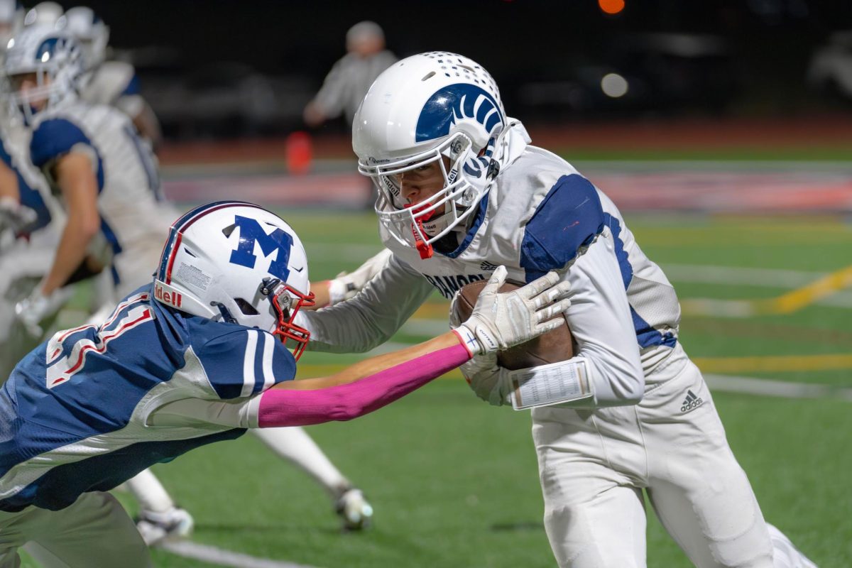 Joey Sommer tries to pick up extra yards as he stiff arms a Mendham defender.