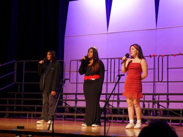 From left: Freshmen Aaryan Raghavan, Isabella Bello and Sophia Van Antwerp sing “Love on the Brain” by Rihanna at POPtoberfest on Oct. 18.  
