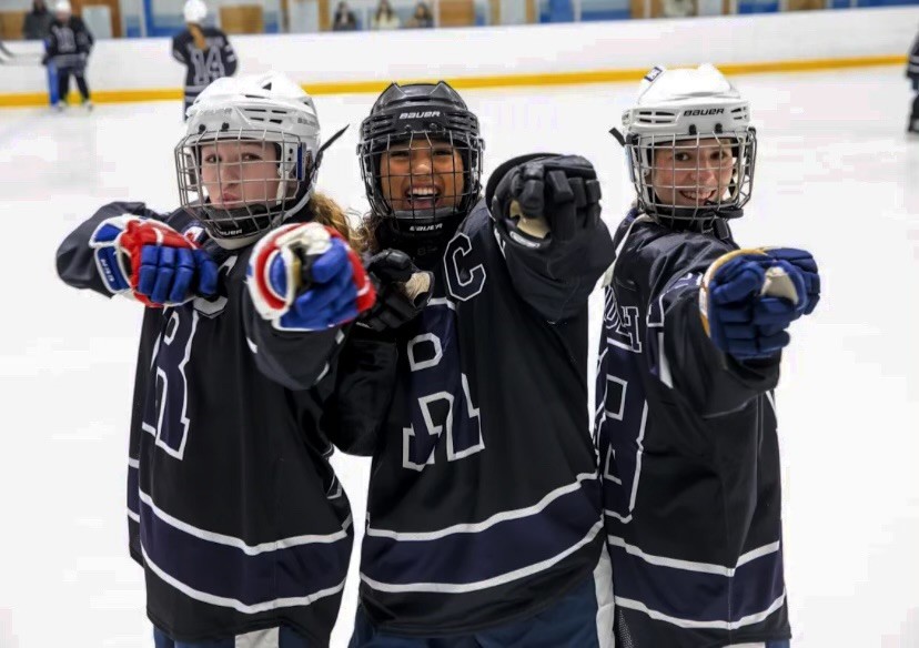 Members of the Girls Ice Hockey team celebrate after their 7-6 win against Princeton on Wednesday, Dec. 18. 