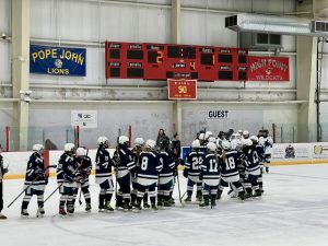 The Rams line up to shake hands with the Cougars following an intense overtime battle that ended with Randolph's 2-1 win, as shown on the scoreboard overhead. 