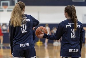 Junior Irene Pardo (left) and senior Morgan Heller warm up before a game last season.