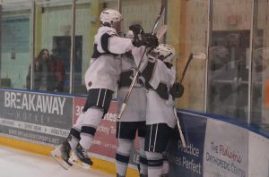 Boys Ice Hockey celebrates after making a goal during a scrimmage last season.  