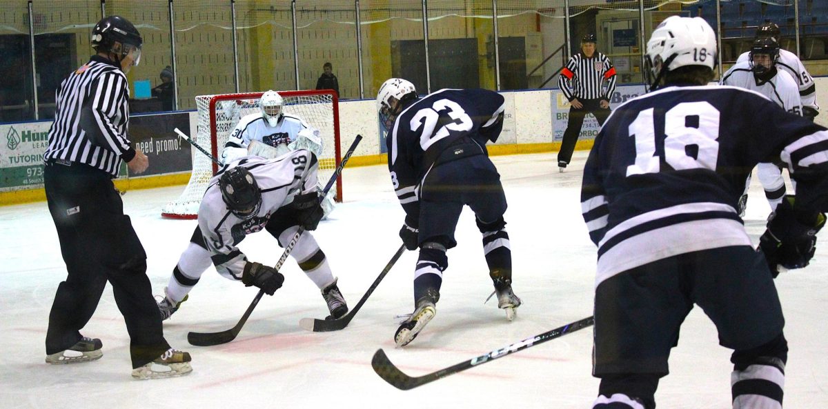 Senior Andrew George slides the puck away from KJS on the way to a 10-3 win for Randolph on Sunday, Jan. 26.  