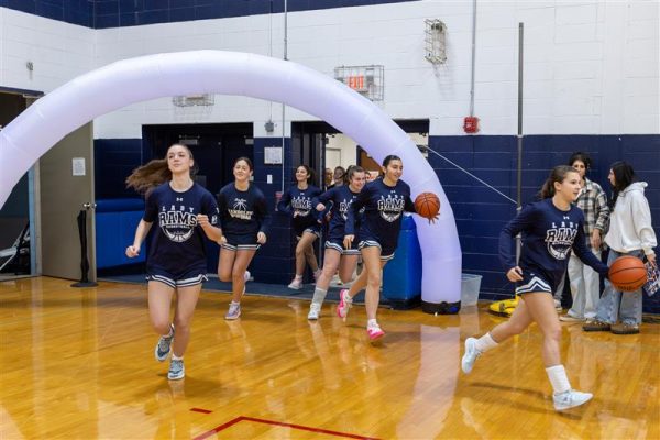 Members of the Randolph Girls Basketball team run out to greet the fans at the start of their Fan Appreciation game and a 49-26 win over Morristown-Beard, on Friday, Jan. 13. 