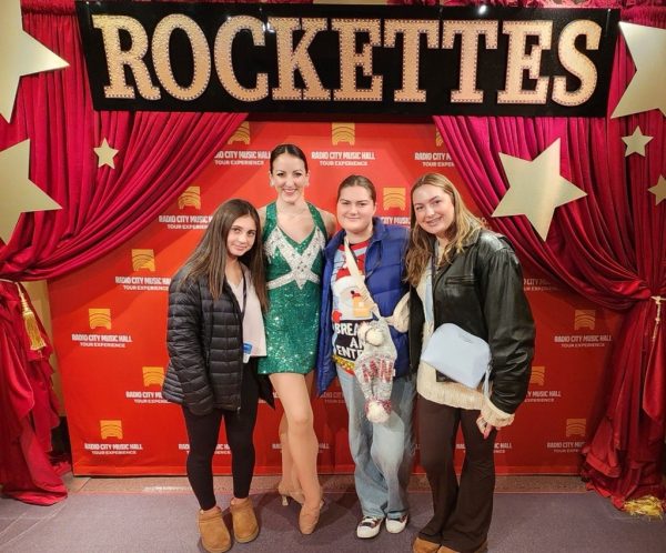 Show reviewer Grace Theerman (right), her twin sister Olivia Theerman (second from right) and their cousin Madelyn Lufft (far left) pose with a Rockette before the big holiday show on Saturday, December 14, 2024.