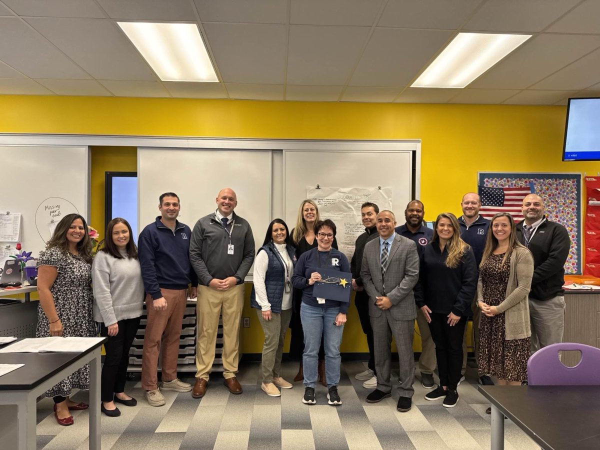 RHS administrators give Dr. Krista Seanor (front, center) the good news that she has been named the high school's Teacher of the Year for 2024-2025 on December 6, 2024. 