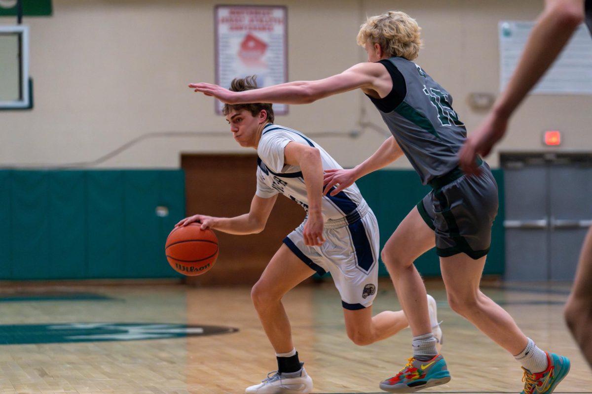 Ryan Warner drives right fighting a Delbarton defender on the way to a 79-19 loss in the first round of the Morris County Tournament (MCT) on Wednesday, Feb. 5.