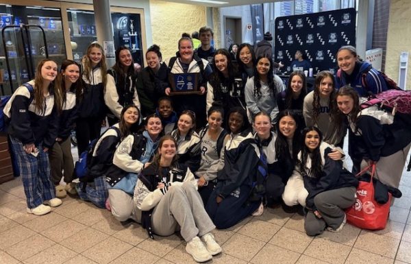 The team comes together and poses with their new trophy after the historic meet.  