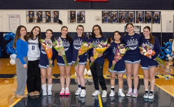 
Seniors on the Girls Basketball team line up for a picture on Senior Night, after being honored for their commitment to the team. 

