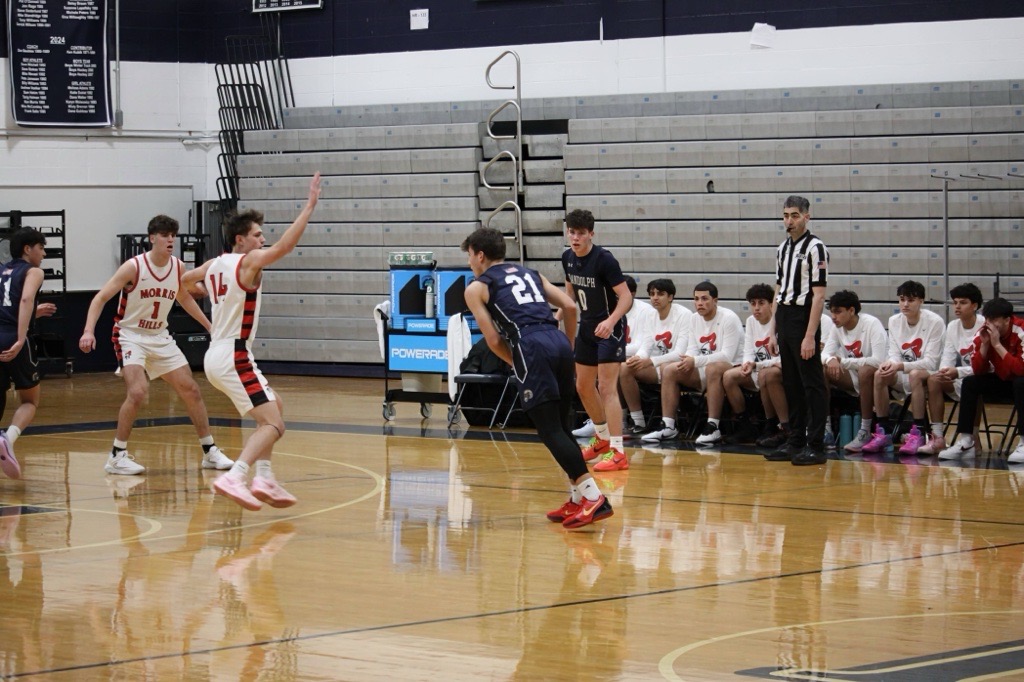 Andrei Nitulescu (21) drives to the basket trying to break away from the Morris Hills defender on the way to a Rams victory, 46-38, on Wednesday, Jan 8.  