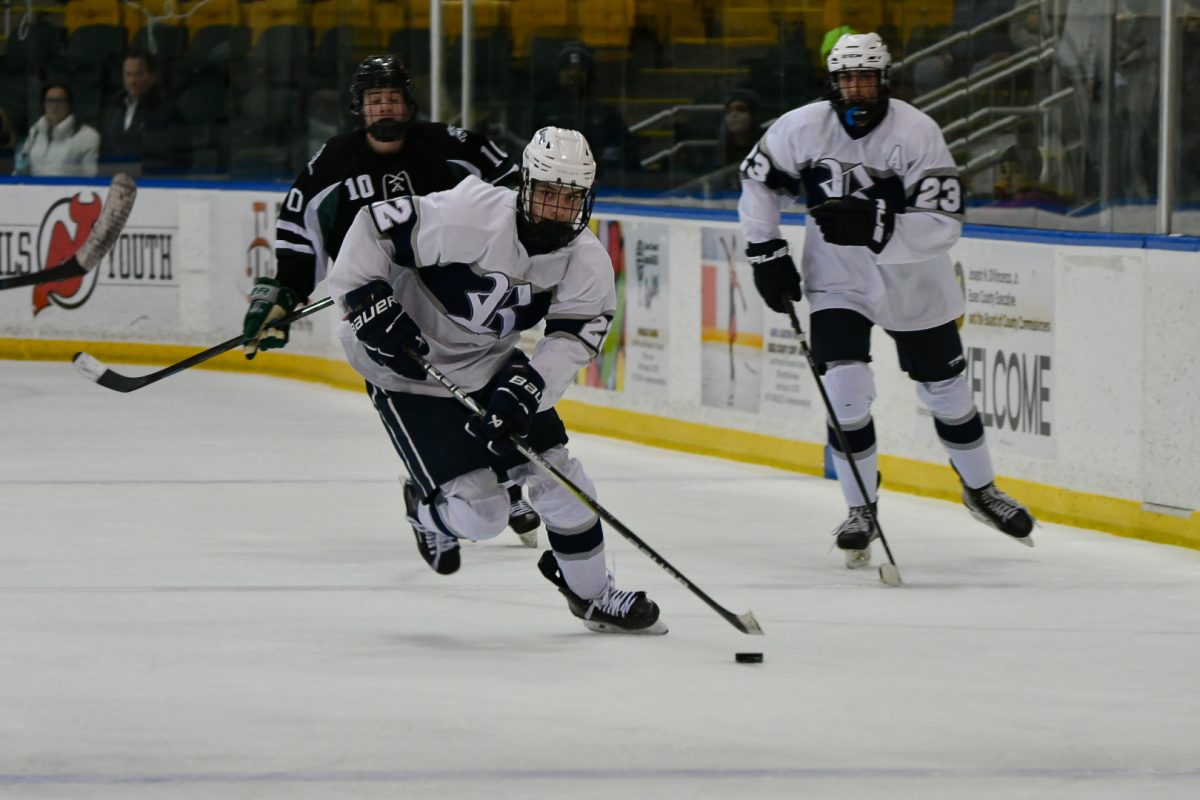 Boys Ice Hockey Ram Shane Melly caries the puck down the ice before taking a shot on net on the way to a semis win for Randolph against Livingston on Monday, March 3, 2025. 