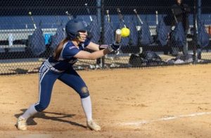 Senior co-captain Rebecca Dasti bunts the ball to quickly get to base for Randolph, on the way to an 11-2 win against Morris Hills on April 24, 2025.

