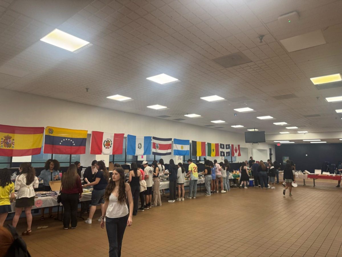 Members of the Spanish and French Honor Societies and Team Harmony host the annual Global Café in the high school Commons on Friday, May 2, 2025.