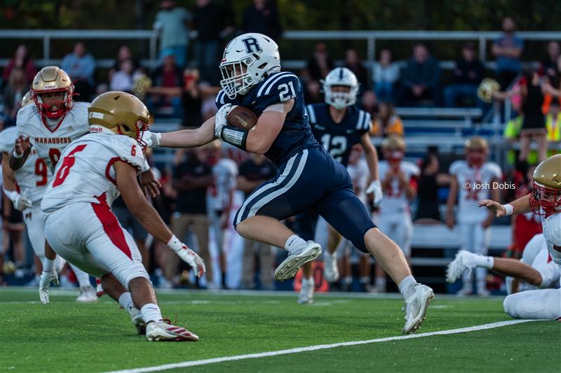Sophomore Dillon Hines (21) pushed away the Mount Olive defender to run down the field on the way to a 43-7 loss on Friday, Sept. 12, 2025.