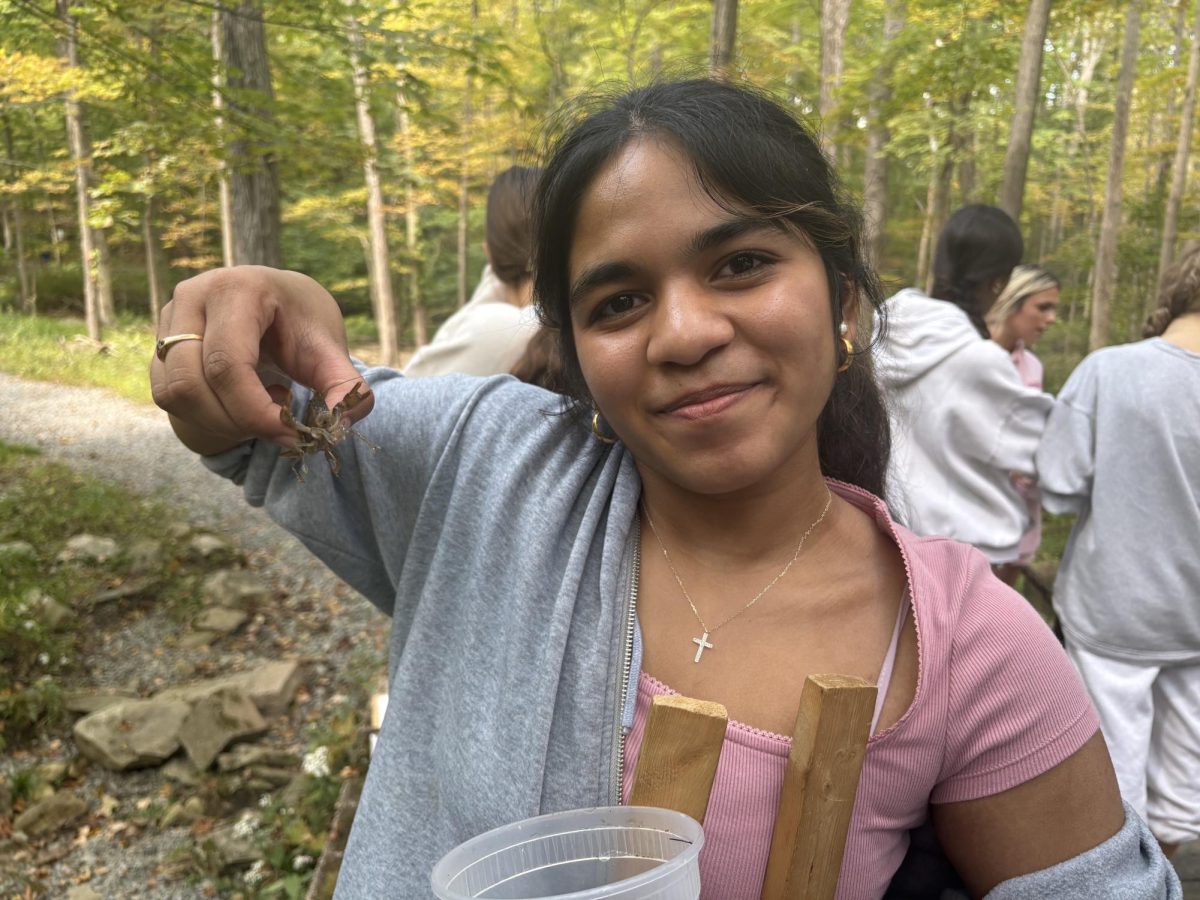 Sophomore Sarah Samtackamy holds a crayfish from the Randolph Trails creek during the annual AP Environmental Science nature walk on Monday, Sept. 15, 2025.