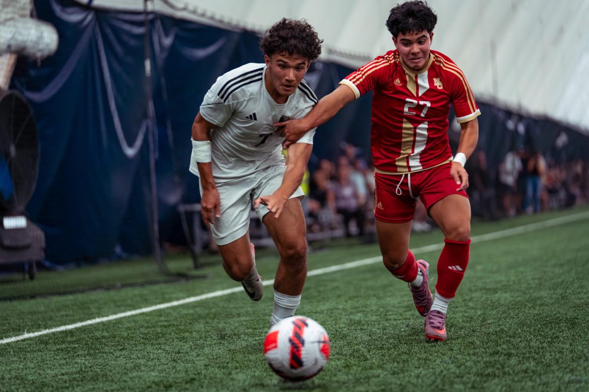 Junior Julian Hernandez fights for the ball down the wing in a tight, season-opener game against Mount Olive, which ended in a 2-1 win for Randolph, on Thursday, Sept. 4, 2025. 