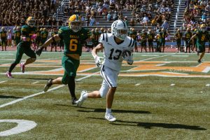 Sophomore Tyler Bachrach (#13) runs down the field, capturing the ball against Morris Knolls on Saturday, Sept. 20, 2025. 