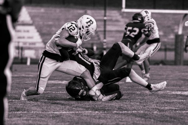 Senior Ram Steven Nostrame (12) fights off a Teaneck Highwayman for extra yardage in Randolph Football's season opener on Friday, August 29, 2025. 