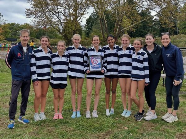 Girls Cross-Country shows off the team's winning plaque following the NJAC Championships on Tuesday, Oct. 14, 2025. 