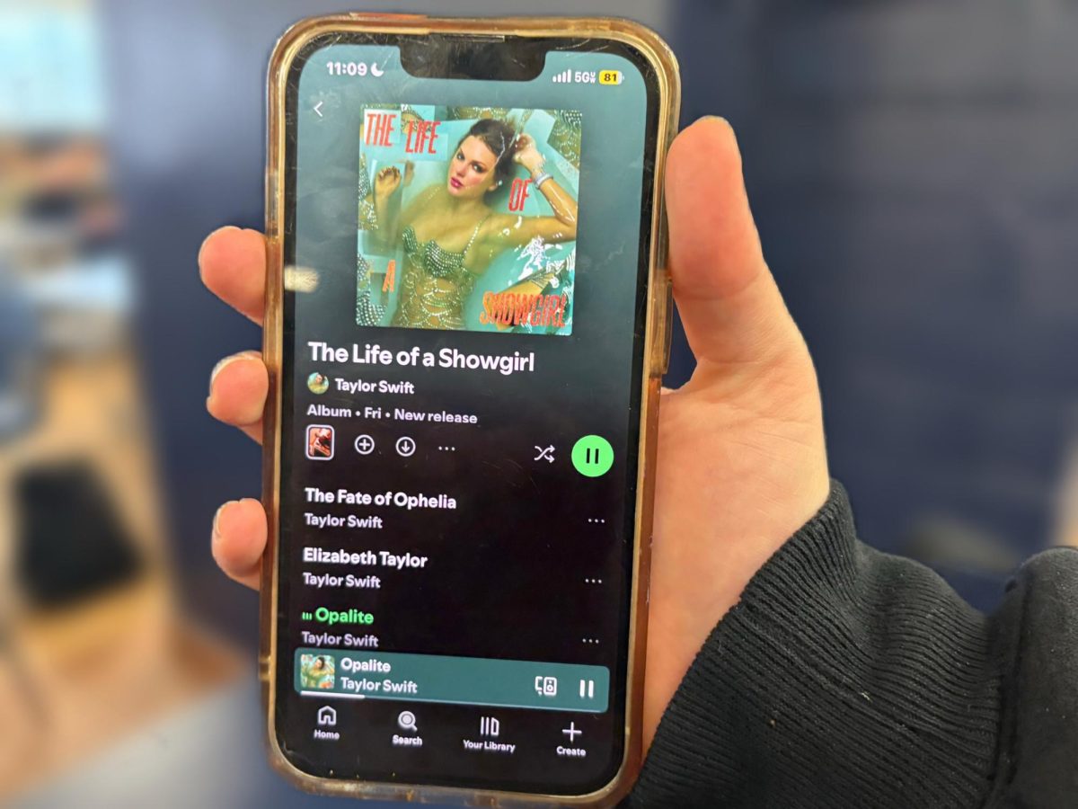 Senior Rachel Kellett listens to “Opalite,” a song from Taylor Swift’s new album, "The Life of a Showgirl," on her iPhone. 