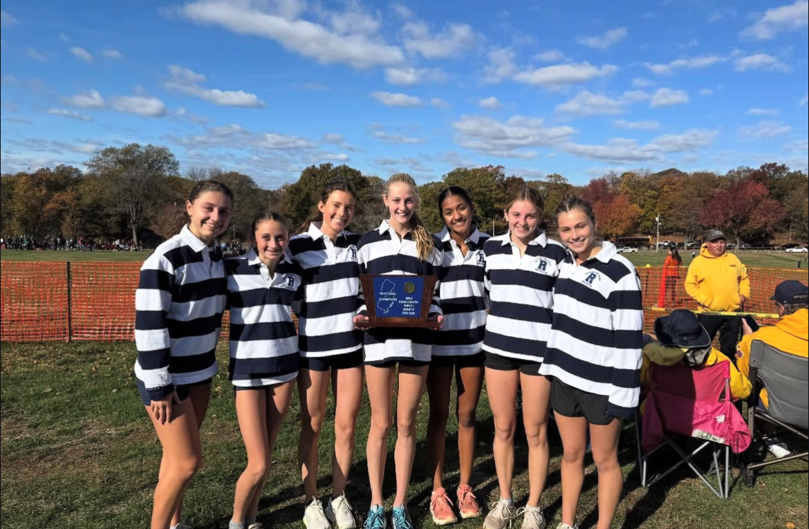 Girls X-C shows off the team's championship trophy after winning the State Sectional race on Nov. 1, 2025. 