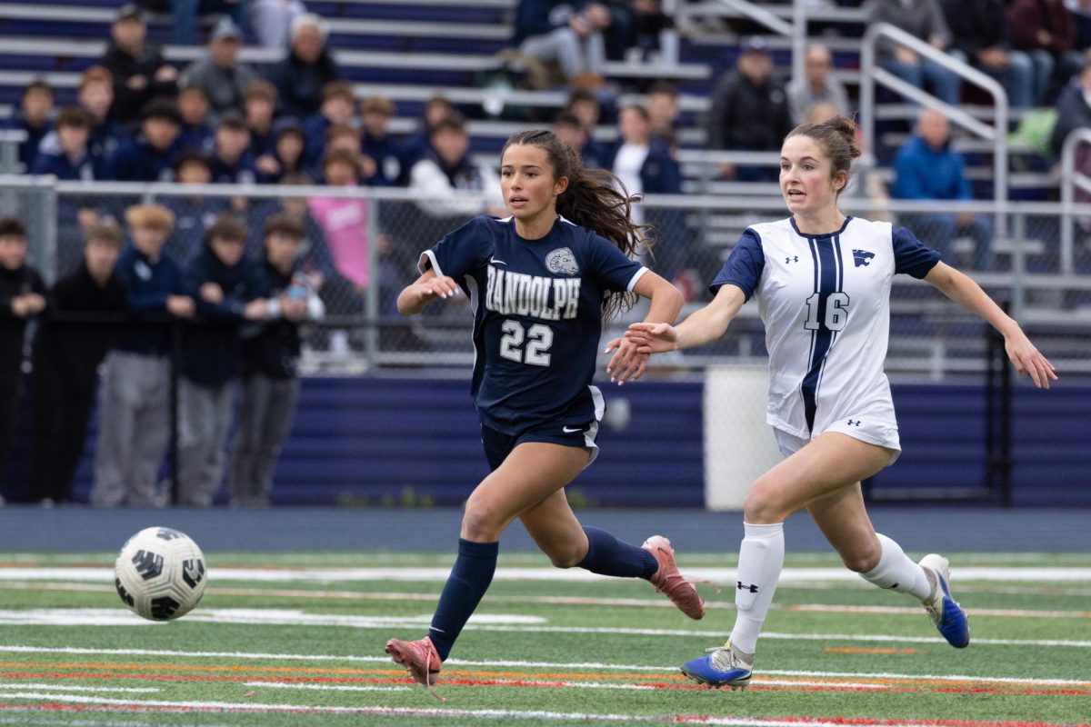 Sophomore Dana Cozza (22) pushes forward toward the goal after sprinting past a Chatham defender in the county finals on Oct. 25, 2025.   
