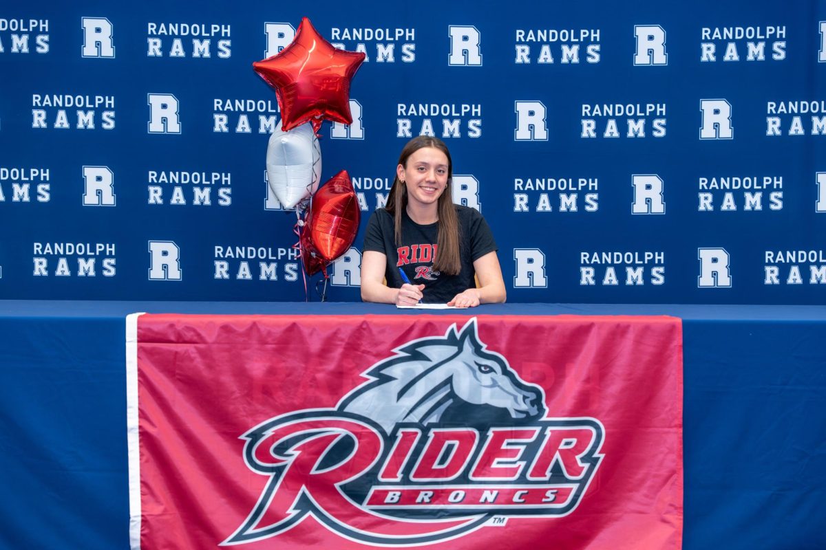 Syd Wright signs to swim for Rider University on Feb. 9, 2026. 