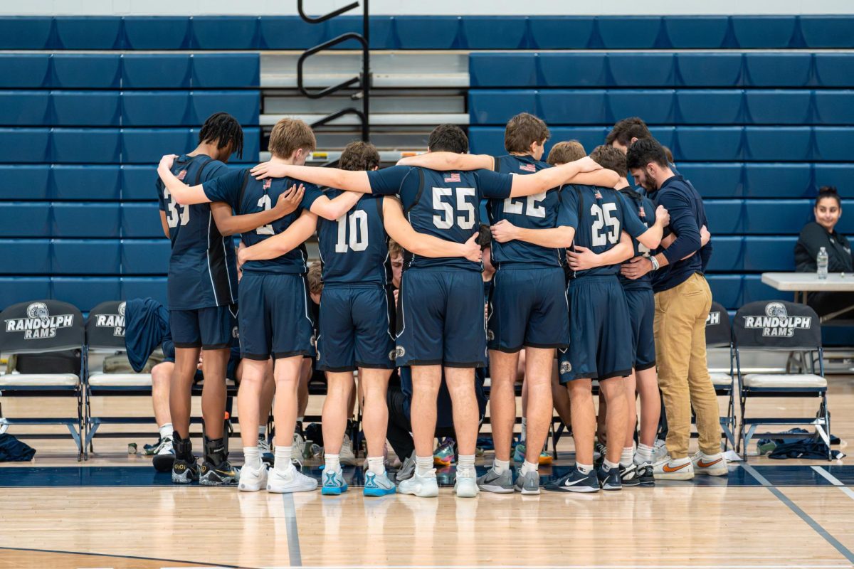 The 2025-26 Boys Basketball team huddles up during a timeout. 