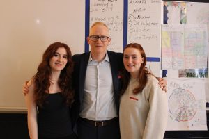 Retired FBI Agent Mark Kellett (center) stands with his twin daughters, RHS juniors Grace Kellett (left) and Rachel Kellett (right) after speaking to mock trial and criminal justice students about his career with the agency on Thursday, March 12. 