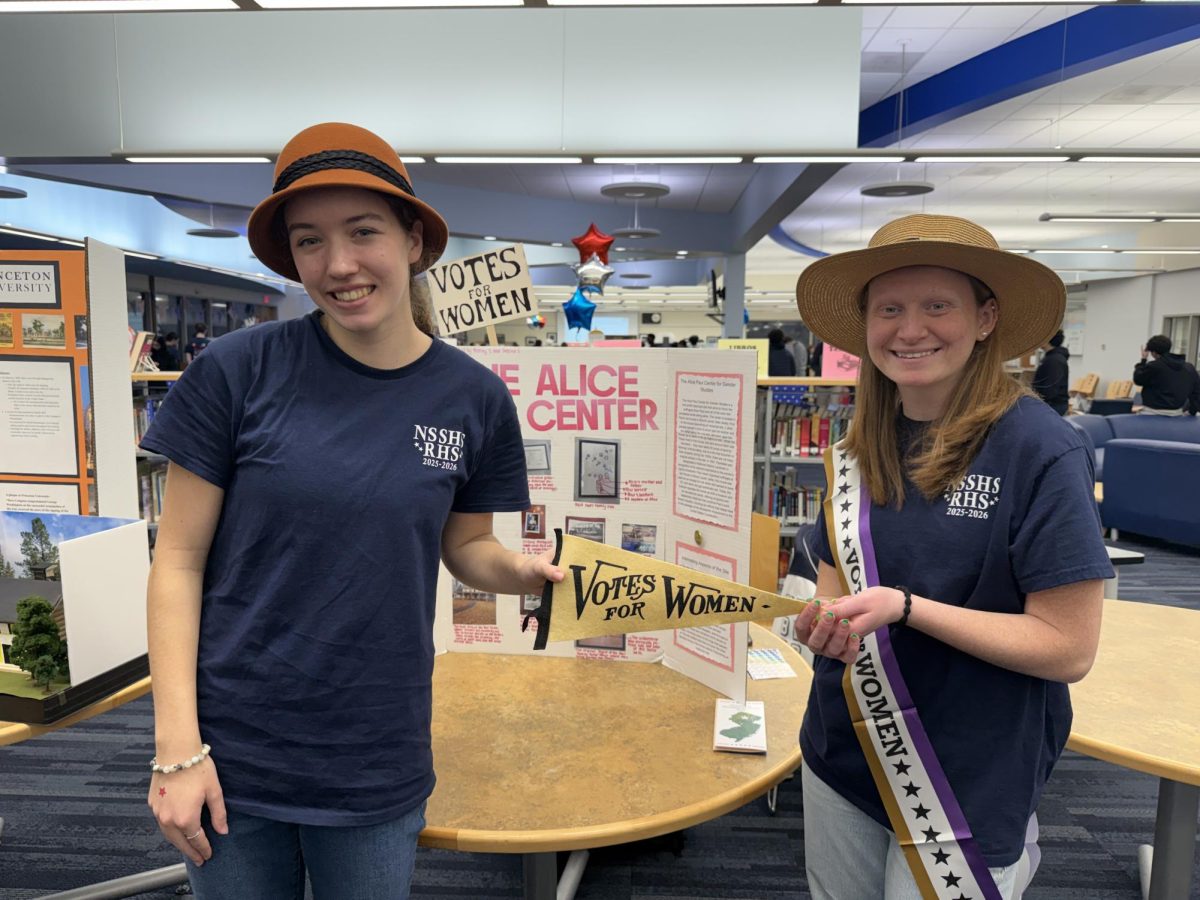 Jessica Leonard (left) and Ashley Silvestri present their trifold on The Alice Paul Center at Red, White, & Jersey at RHS on March 5, 2026.
 