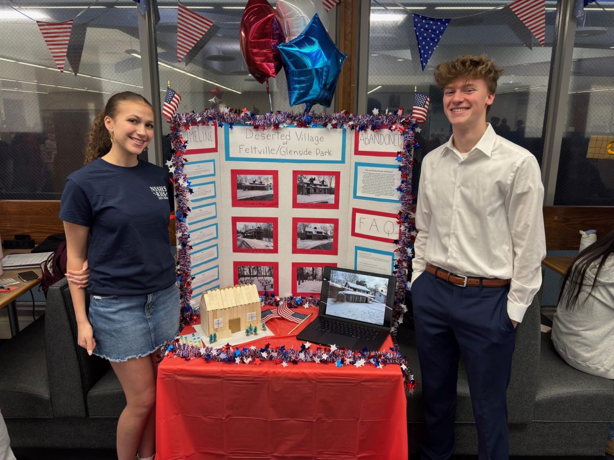 Julia Vitale (left) and Andrew Walker present their trifold on the Deserted Village of Feltville/Glenside Park at Red, White, & Jersey at RHS on March 5, 2026.