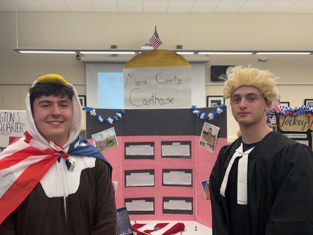Costumed presenters Ethan Dougherty (left) and Jackson Stein present their trifold on the Morris County Courthouse at Red, White, & Jersey at RHS on March 5, 2026.