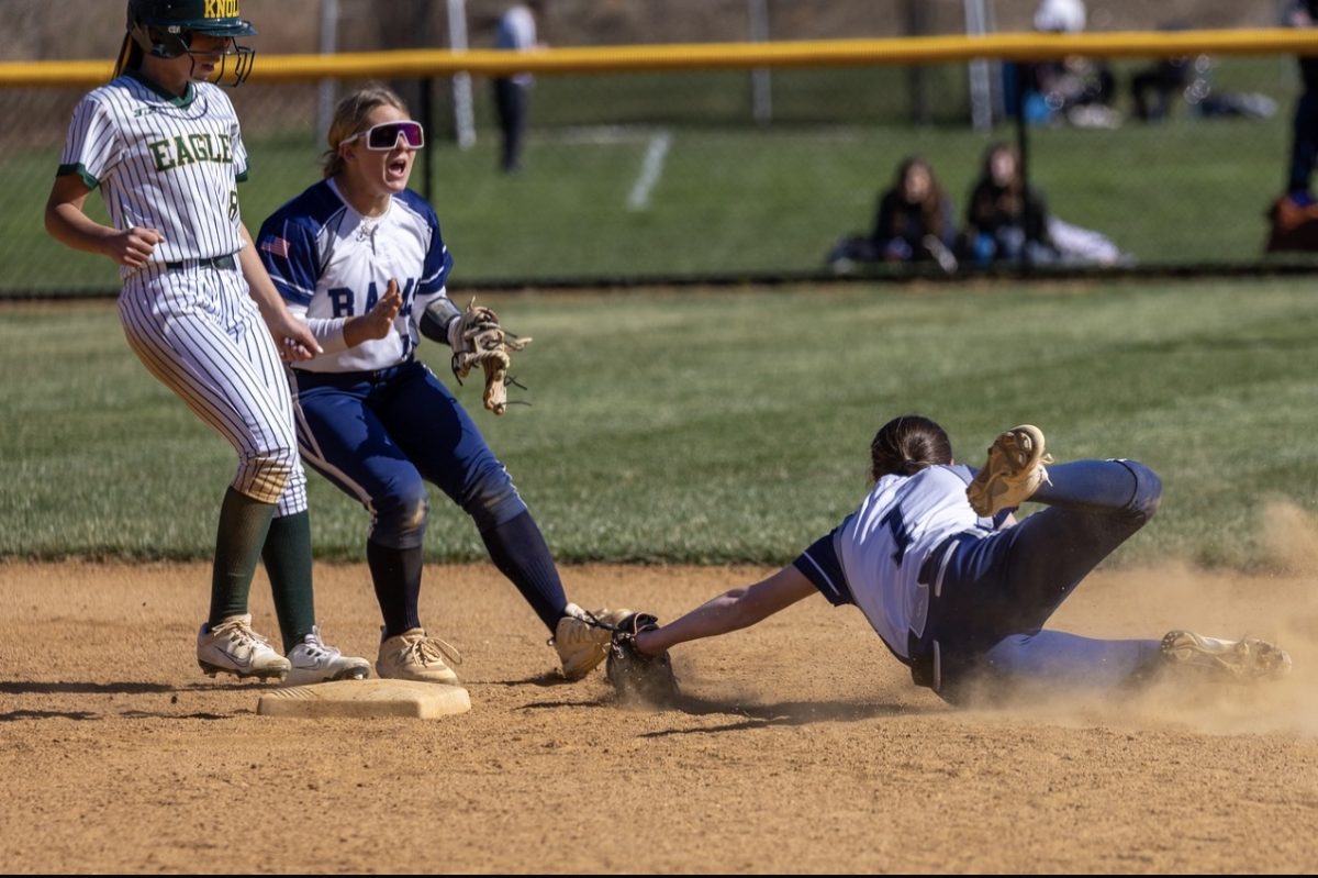 Caitlin Sedorak dives for a catch behind second base as Devyn Meyers guards the play on Wednesday, April 8, 2026.