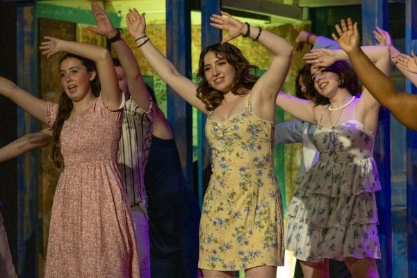 Senior Lauren Rodgers (center) performs in the Spring 2026 production of 'Mamma Mia!' alongside freshman Kate Pepitone (left) and junior Libby Cooper (right).