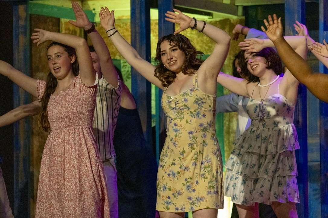 Senior Lauren Rodgers (center) performs in the Spring 2026 production of 'Mamma Mia!' alongside freshman Kate Pepitone (left) and junior Libby Cooper (right).