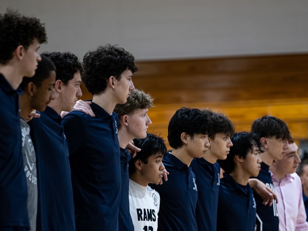 Boys Volleyball players link arms before a recent game in the 2025-26 season.