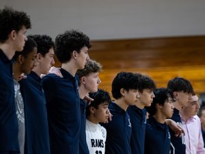 Boys Volleyball players link arms before a recent game in the 2025-26 season.