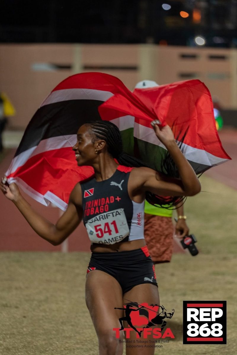 RHS track and field star Seannah Parsons carries the flag for Trinidad and Tobago, her home country, after competing in the Carifta Games on Saturday, April 4, 2026. Photo: DENNIS ALLEN for @TTGameplan